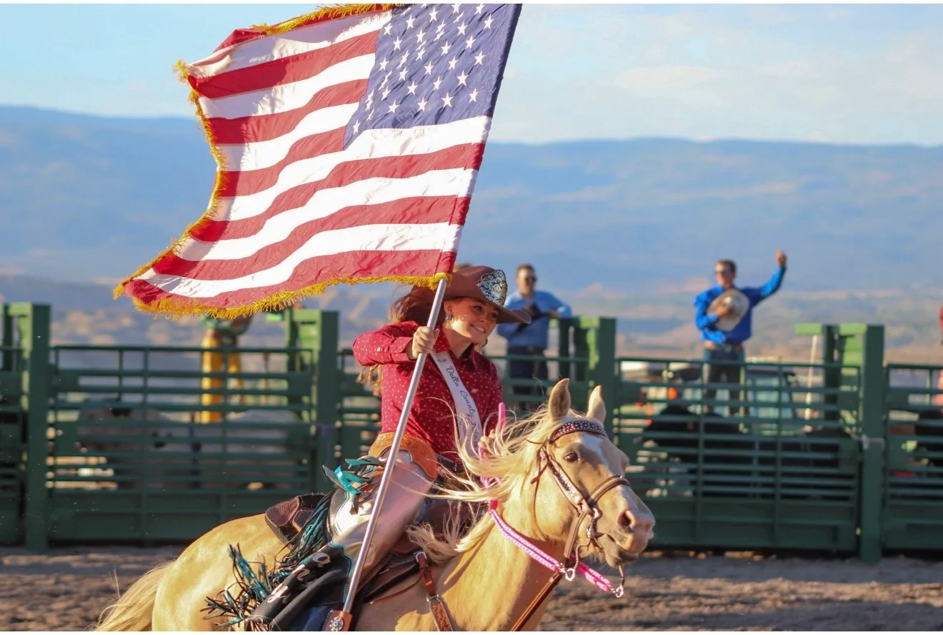 Flag bearer on horseback opening the rodeo at Grand View.